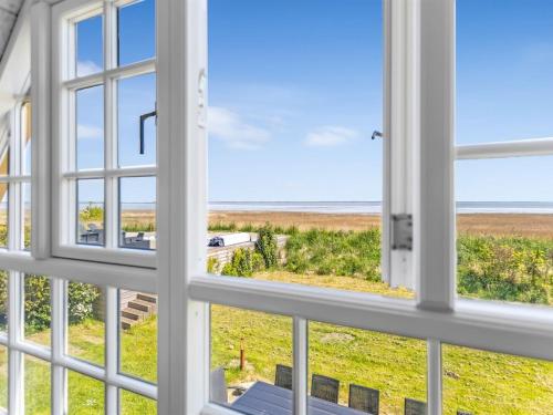 a view of the beach from the window of a house at Holiday Home Narvik - 4-5km from the sea by Interhome in Kongsmark