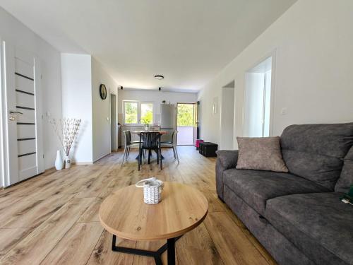 a living room with a couch and a table at Robinson Edita in Bogomolje