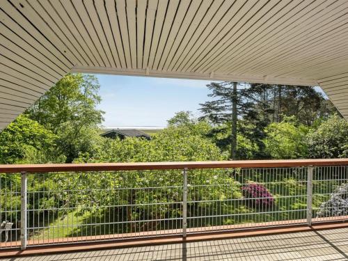 a balcony with a view of a garden at Holiday Home Iiro - 2-5km from the sea by Interhome in Rømø Kirkeby