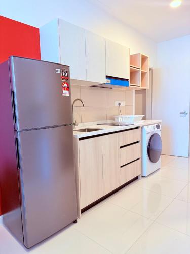 a kitchen with a stainless steel refrigerator and a dishwasher at Majestic Residence Klcc in Kuala Lumpur
