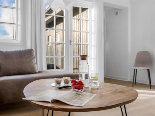 a coffee table in a living room with a bottle of wine at Holiday Home Dragan - 350m from the sea by Interhome in Vejers Strand