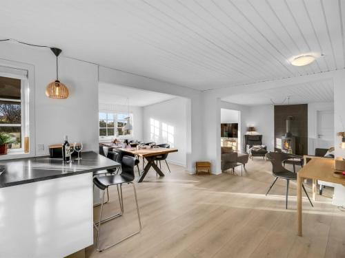 a kitchen and living room with a table and chairs at Holiday Home Dragan - 350m from the sea by Interhome in Vejers Strand