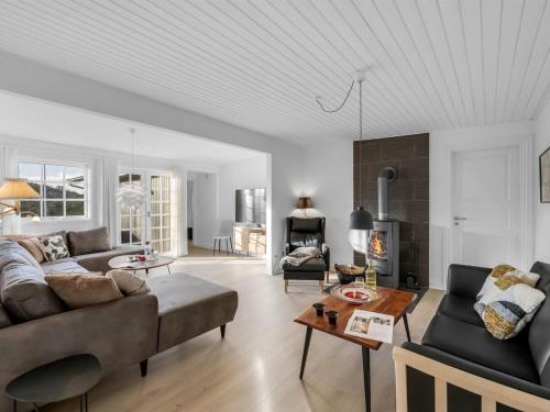 a living room with a couch and a table at Holiday Home Dragan - 350m from the sea by Interhome in Vejers Strand