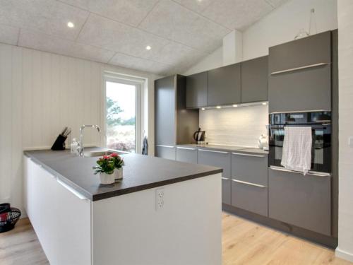 a kitchen with gray cabinets and a counter top at Holiday Home Jirina - 750m from the sea by Interhome in Vejers Strand