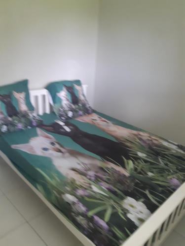 a bed with a picture of a dog on it at Résidence LE LATANIER in Sainte-Anne