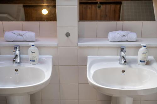 a bathroom with two sinks and two bottles of soap at Luxury Spacious 3 Bedroom, 3 Bathroom Apartment, Walk to Soho, West End, Covent Garden, China Town, Piccadilly in Minutes in London