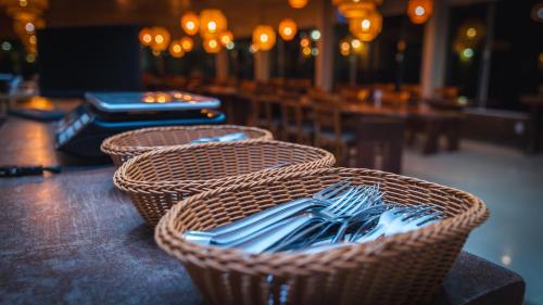 three wicker baskets sitting on top of a table at Pousada Itajuípe- Unidade Itabuna-Ba in Itabuna