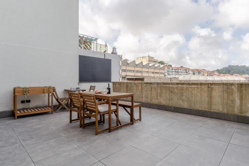 a room with a table and chairs on a balcony at Modern & Sleek Flat | Terrace & Garage by HostWise in Porto