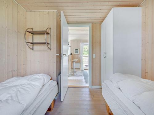 two beds in a room with a hallway at Holiday Home Asvalde - 150m from the sea by Interhome in Vejers Strand