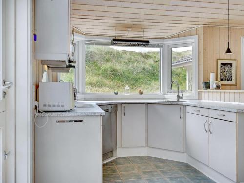 a kitchen with a sink and a window at Holiday Home Asvalde - 150m from the sea by Interhome in Vejers Strand