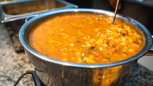 a pot of corn soup sitting on a stove at Pousada Itajuípe- Unidade Itabuna-Ba in Itabuna