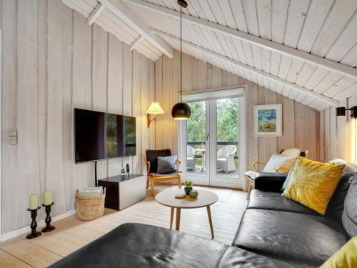 a living room with a couch and a table at Holiday Home Rumena - 800m from the sea by Interhome in Blåvand