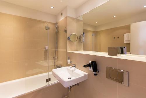 a bathroom with a sink and a shower at B&O Parkhotel in Bad Aibling