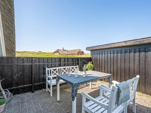 a patio with a table and chairs on a patio at Holiday Home Klimentina - 150m from the sea by Interhome in Ringkøbing