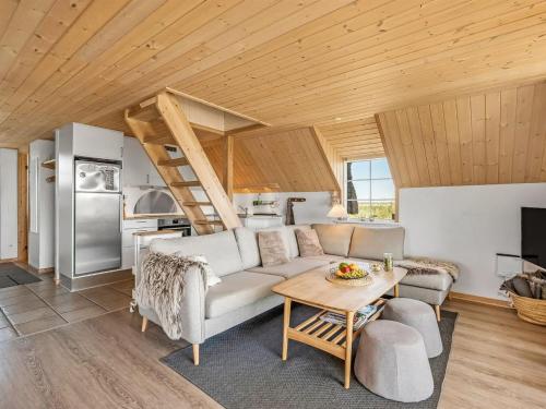 a living room with a couch and a table at Holiday Home Klimentina - 150m from the sea by Interhome in Ringkøbing