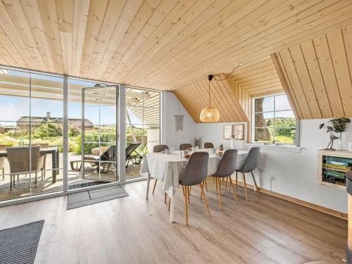 a dining room with a table and chairs at Holiday Home Klimentina - 150m from the sea by Interhome in Ringkøbing