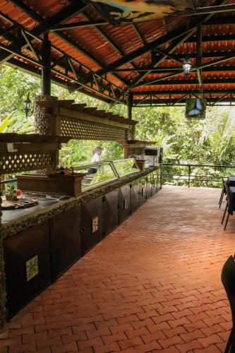 a patio with a bar and a person preparing food at Tapirus Lodge and Reserve in Carrillo