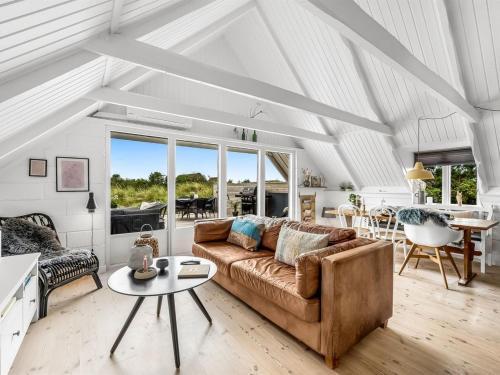 a living room with a couch and a table at Holiday Home Hen - 400m from the sea by Interhome in Ringkøbing