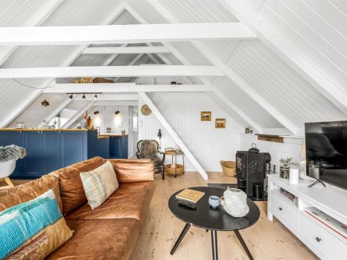 a living room with a couch and a table at Holiday Home Hen - 400m from the sea by Interhome in Ringkøbing