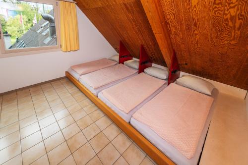 an overhead view of a room with three beds at Delémont Youth Hostel in Delémont