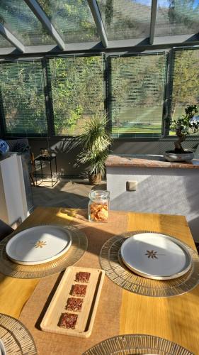 a table with two white plates on top of it at Le sapin bleu in Hastière-par-delà