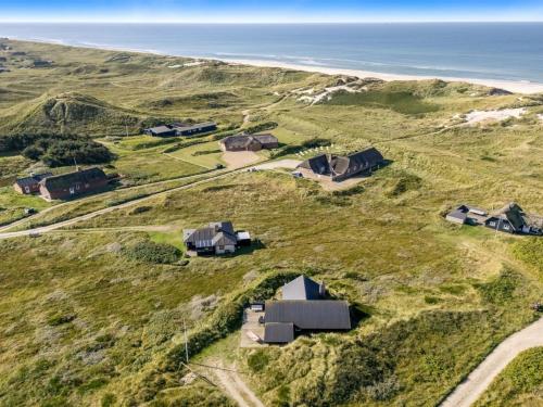an aerial view of a house on a hill next to the ocean at Holiday Home Eggert - from the sea by Interhome in Ringkøbing