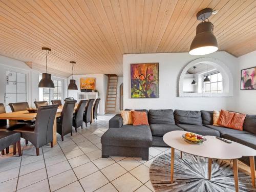 a living room with a couch and a table at Holiday Home Lemmikki - 1-5km from the sea by Interhome in Ringkøbing
