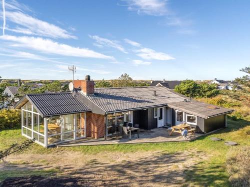 a house with a conservatory on a hill at Holiday Home Shalez - from the sea by Interhome in Bjerregård