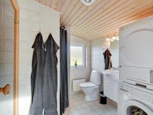 a bathroom with a toilet and a sink at Holiday Home Shalez - from the sea by Interhome in Bjerregård