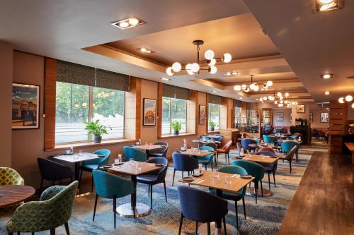 a dining room filled with tables and chairs at Thistle London Hyde Park Kensington Gardens in London