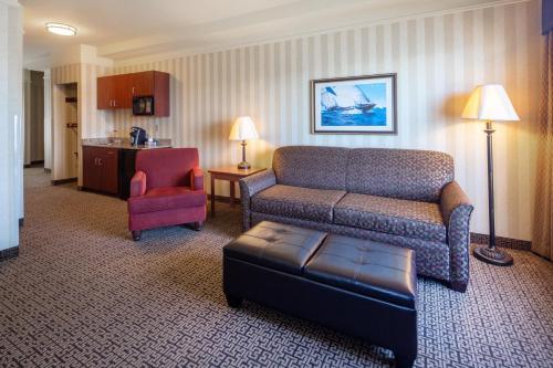 a living room with a couch and a chair at Holiday Inn Express Hotel & Suites Astoria by IHG in Astoria, Oregon