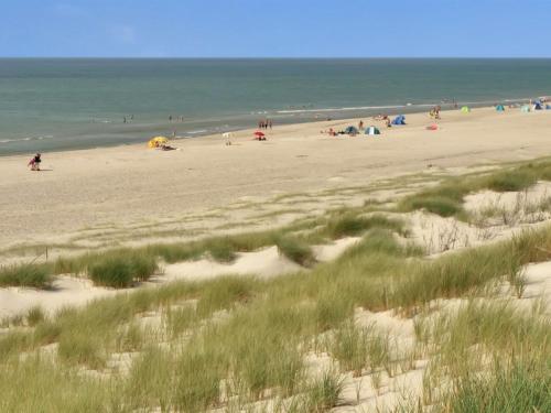 a beach with a lot of people and the ocean at Holiday Home Ozeana - from the sea by Interhome in Bjerregård