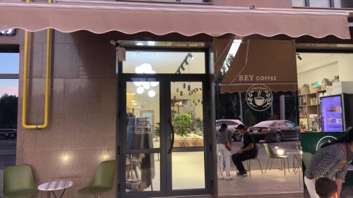 a store front with people sitting outside of it at Baht in Bishkek