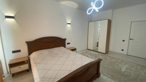 a bedroom with a bed and a large mirror at Baht in Bishkek