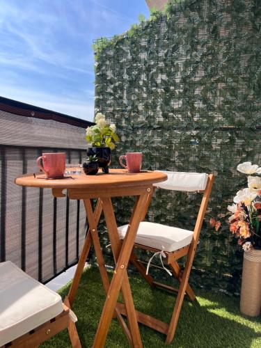 a wooden table and two chairs on a patio at Mirkovic Lux apartman in Niš