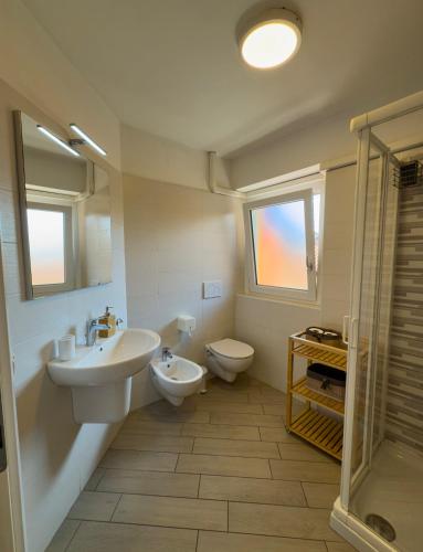 a bathroom with a sink and a toilet at BelSorrisoVarese - Elegance City Residence Private Parking -Reservation Required- in Varese