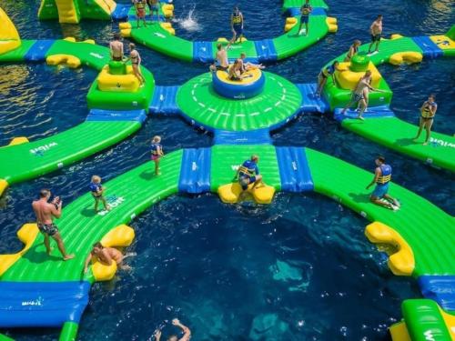 a group of people on an inflatable water park at Le chalet de la Presquile in Giffaumont