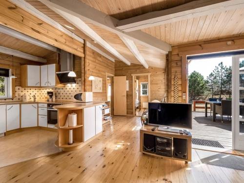 a kitchen and living room in a log cabin at Holiday Home Yaris - 800m to the fjord by Interhome in Bjerregård