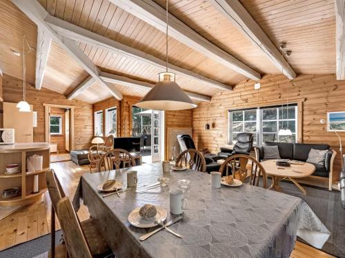 a dining room and living room with a table and chairs at Holiday Home Yaris - 800m to the fjord by Interhome in Bjerregård