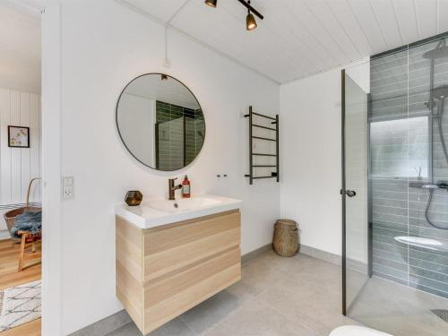 a bathroom with a sink and a mirror at Holiday Home Doreen - from the sea by Interhome in Bjerregård
