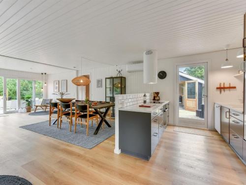 a kitchen and dining room with a table and chairs at Holiday Home Doreen - from the sea by Interhome in Bjerregård