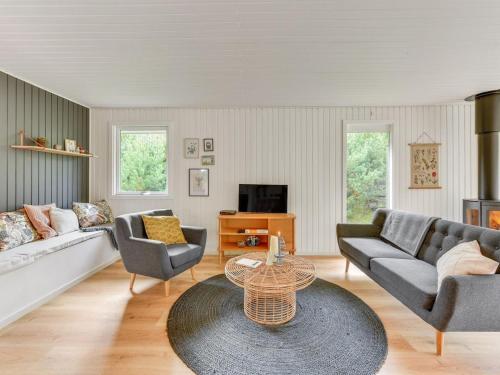 a living room with a couch and chairs and a table at Holiday Home Doreen - from the sea by Interhome in Bjerregård