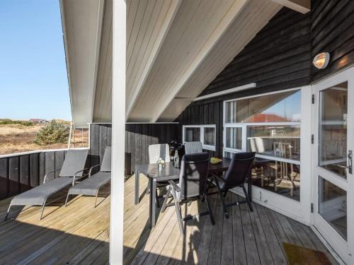 a patio with a table and chairs on a deck at Holiday Home Durita - 600m to the inlet by Interhome in Havrvig