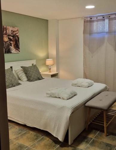 a bed with two pillows on it in a bedroom at Villa Penelope Luxury Retreat with Pool & Timeless Charm in Douliana
