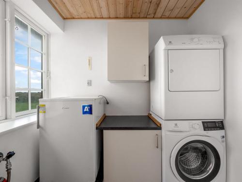 a laundry room with a washing machine and a washer at Holiday Home Dietlinde - 100m from the sea by Interhome in Harboør