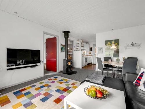 a living room with a couch and a table at Apartment Smeralda - 200m from the sea by Interhome in Lemvig