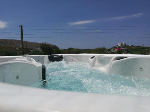 a bathtub with water in it with at Milia Gi Suites in Pollonia
