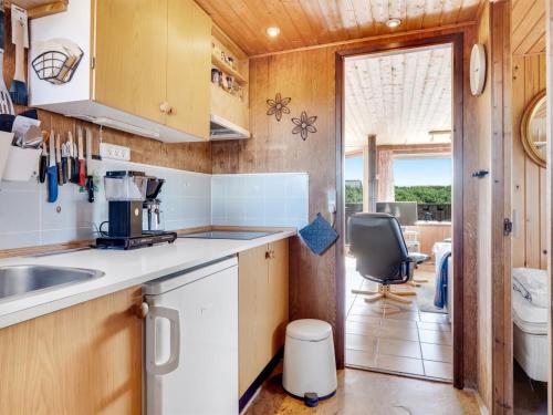 a kitchen with a sink and a counter top at Holiday Home Beatrice - 150m from the sea by Interhome in Lemvig