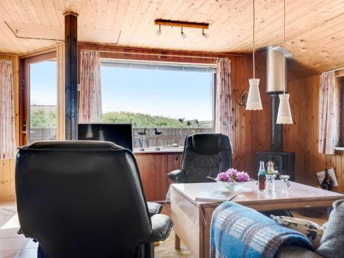 a living room with a table and chairs at Holiday Home Beatrice - 150m from the sea by Interhome in Lemvig