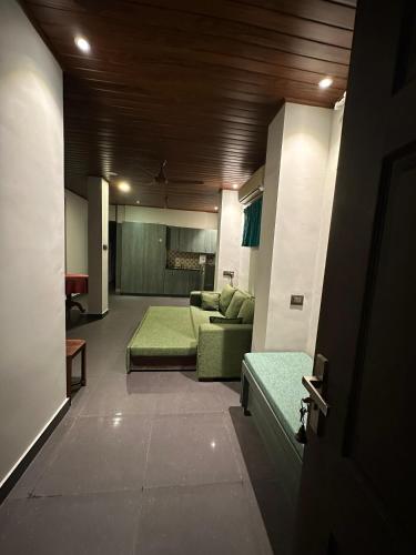 a living room with a couch and a table at Pearl Spot in Alwaye